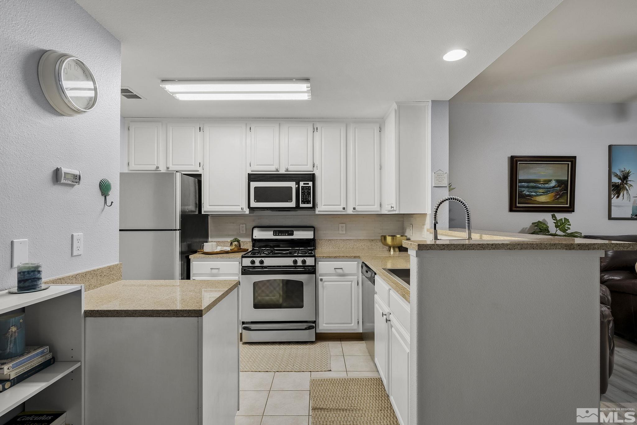 900 South Meadows Parkway, Unit 2012 Reno, NV 89521 - Photo 6 of 17 a kitchen with stainless steel appliances a refrigerator stove microwave and sink