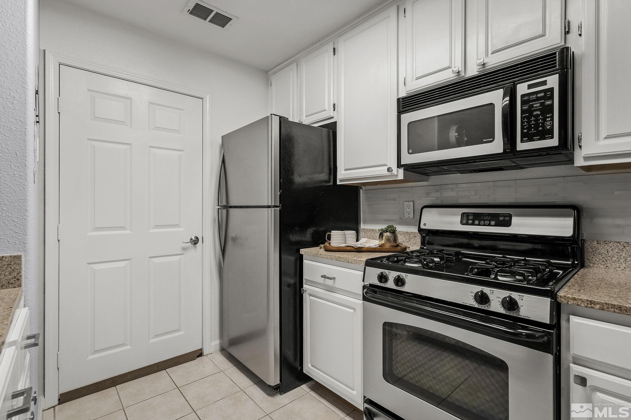 900 South Meadows Parkway, Unit 2012 Reno, NV 89521 - Photo 8 of 17 a kitchen with cabinets and steel stainless steel appliances