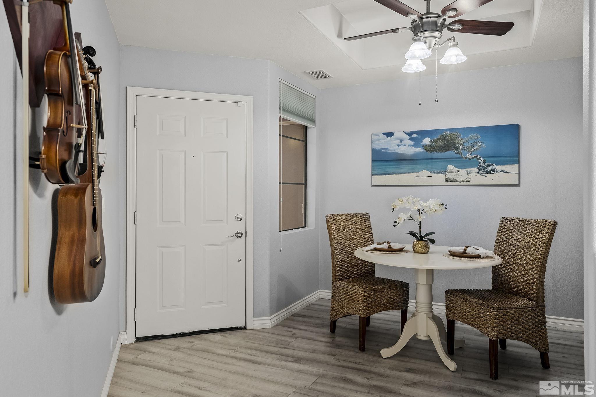 900 South Meadows Parkway, Unit 2012 Reno, NV 89521 - Photo 9 of 17 a view of a dining room with furniture and wooden floor