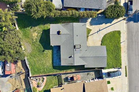 an aerial view of a house with a yard