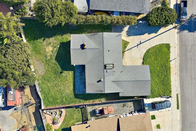 an aerial view of a house with a yard