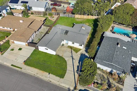 an aerial view of a house with a garden and trees