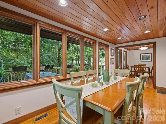 a very nice looking dining room with kitchen island stainless steel appliances a table and chairs
