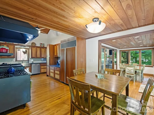 a dining room with furniture window and wooden floor