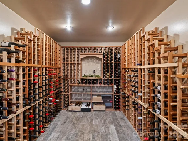 a view of a hallway with wooden floor and windows