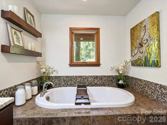 a en suite bathroom with a sink double vanity and a mirror