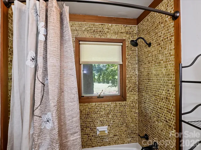 a bedroom with a large bed and a large window