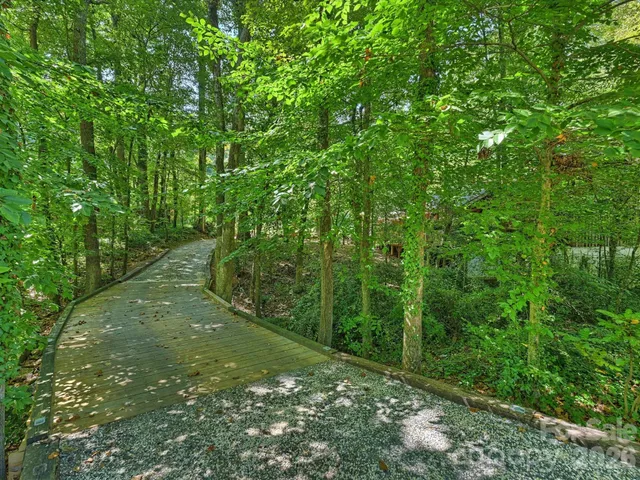a view of yard with swimming pool and green space