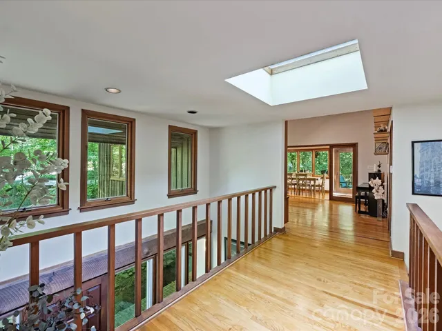 a view of a livingroom with furniture wooden floor and a large window
