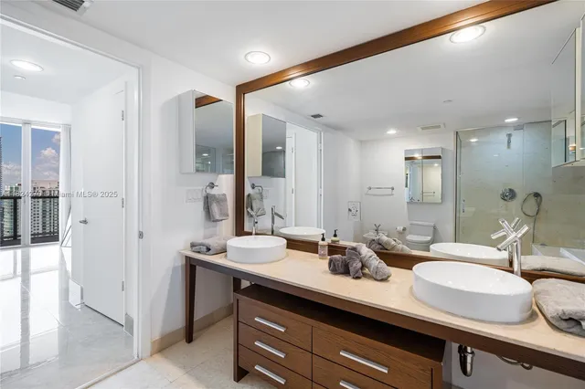a bathroom with a double vanity sink mirror and double
