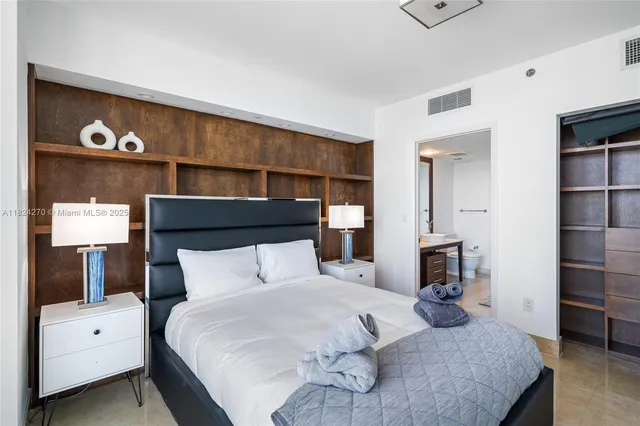 a bedroom with a bed and a television