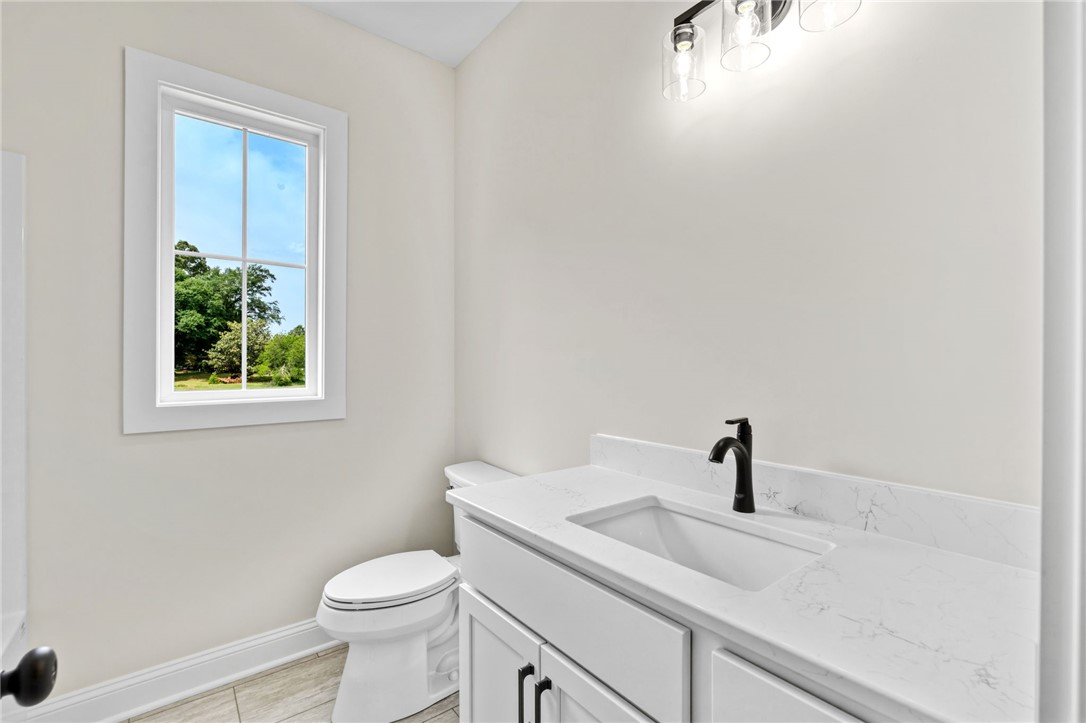 1735 Maw Bridge Road Central, SC 29630 - Photo 26 of 38 This bright bathroom features a modern vanity with elegant countertops and a window for natural light.