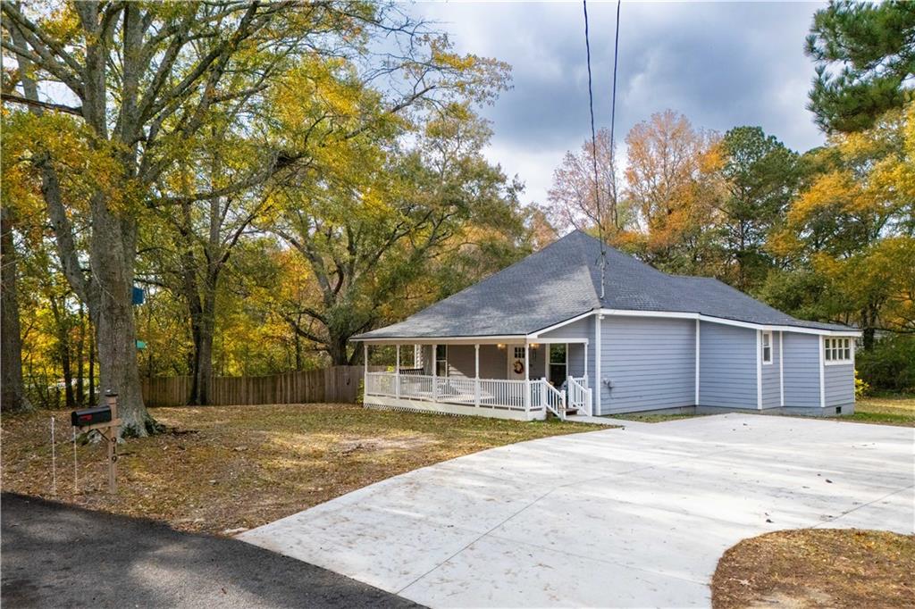 919 1st Street Villa Rica, GA 30180 - Photo 1 of 1 a front view of a house with a yard garage and large tree