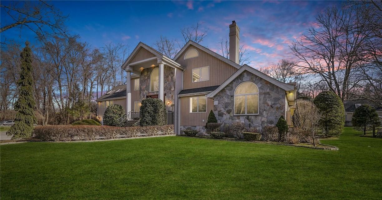 a front view of house with a garden