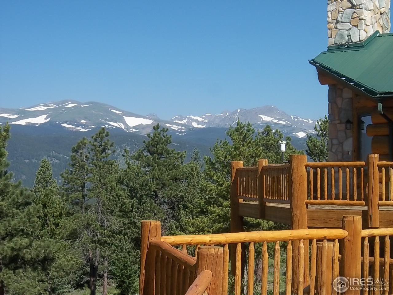 1455 Ridge Road Nederland, CO 80466 - Photo 1 of 40 a wooden fence with trees in the background