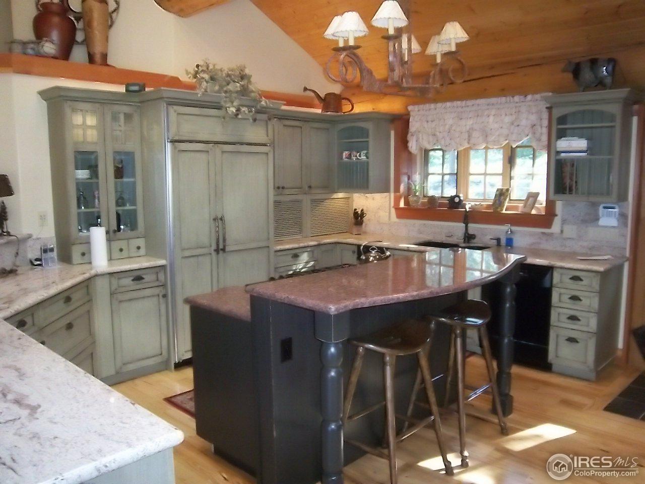 1455 Ridge Road Nederland, CO 80466 - Photo 15 of 40 a kitchen with stainless steel appliances granite countertop a sink stove and refrigerator