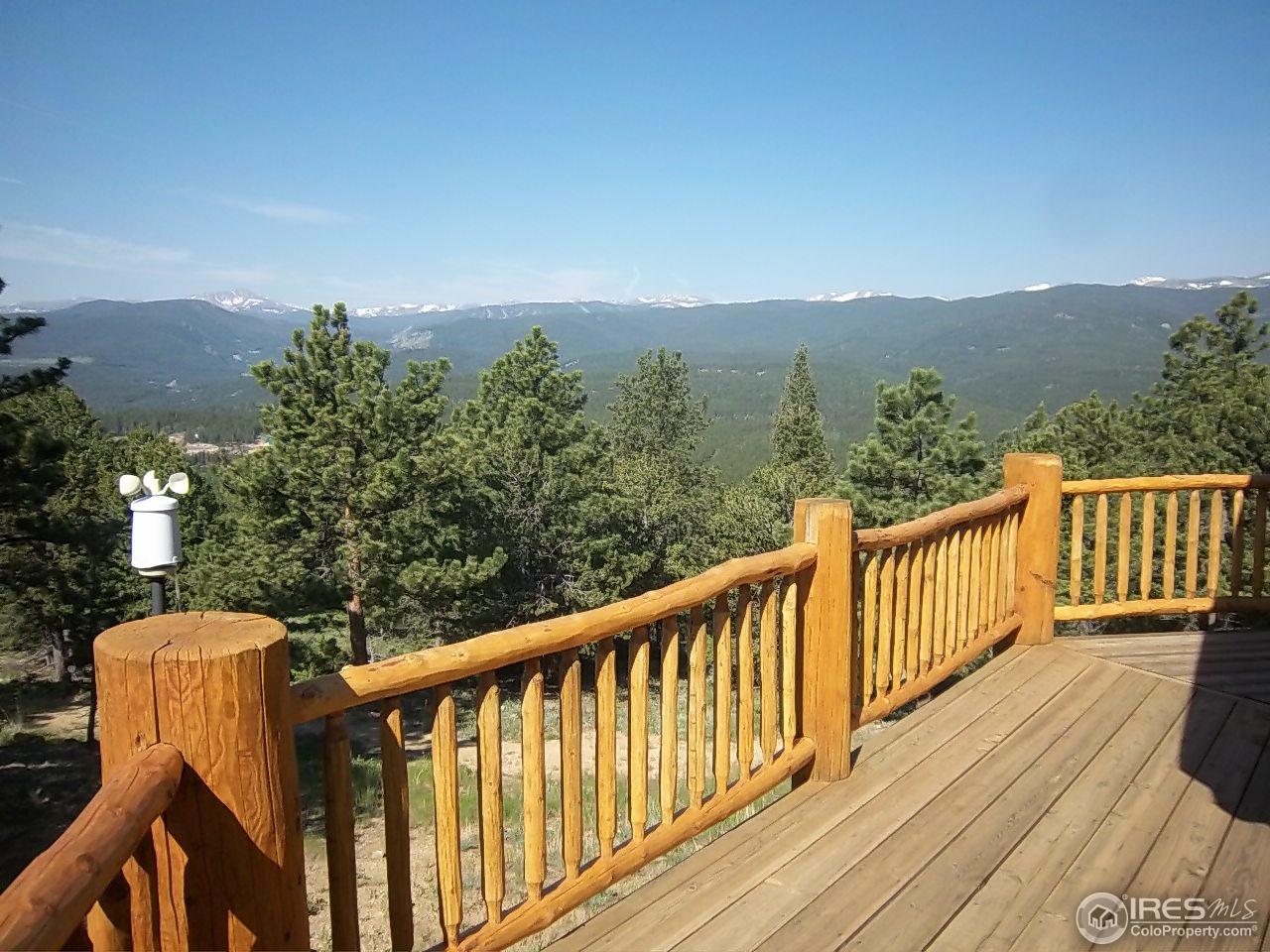 1455 Ridge Road Nederland, CO 80466 - Photo 35 of 40 a view of a balcony with wooden floor and fence