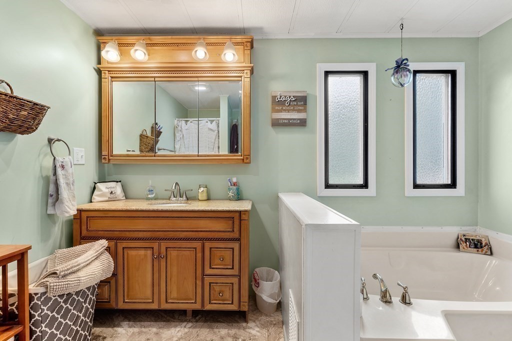 114 Lafayette Road Salisbury, MA 01952 - Photo 17 of 24 a bathroom with a sink a mirror and a bathtub