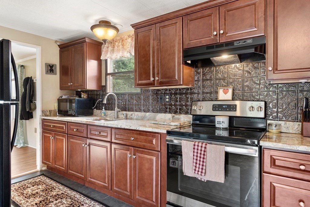 114 Lafayette Road Salisbury, MA 01952 - Photo 3 of 24 a kitchen with stainless steel appliances granite countertop a stove a sink and a microwave