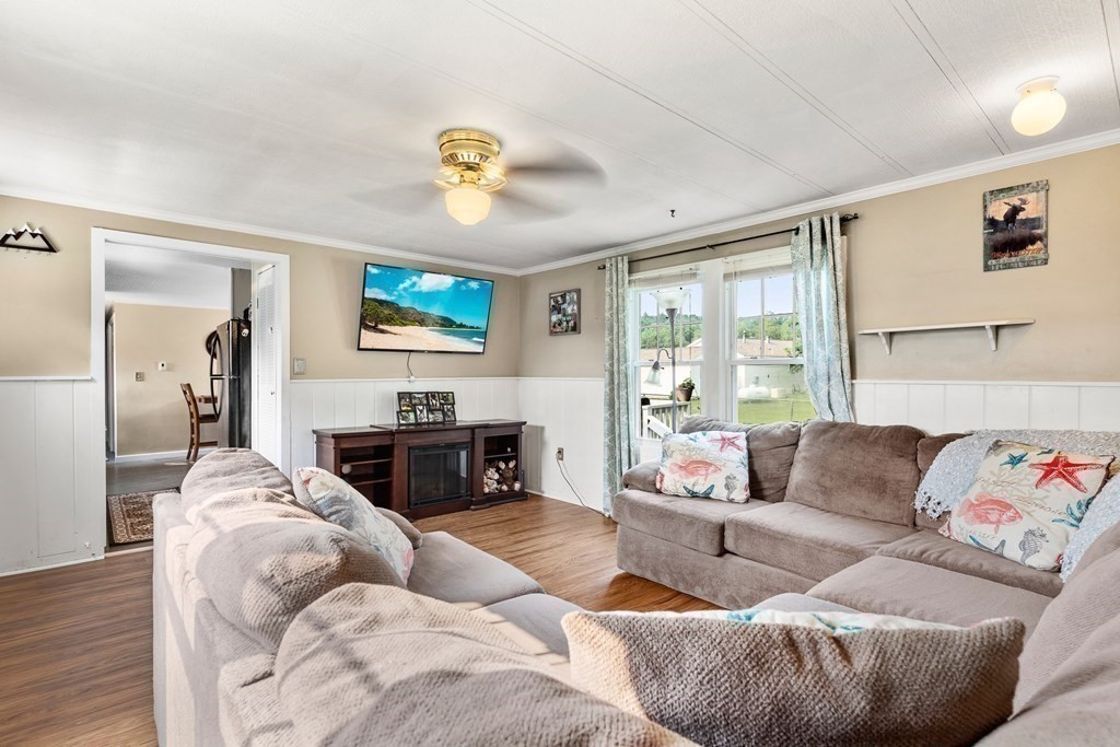 114 Lafayette Road Salisbury, MA 01952 - Photo 8 of 24 a living room with furniture a fireplace and a flat screen tv