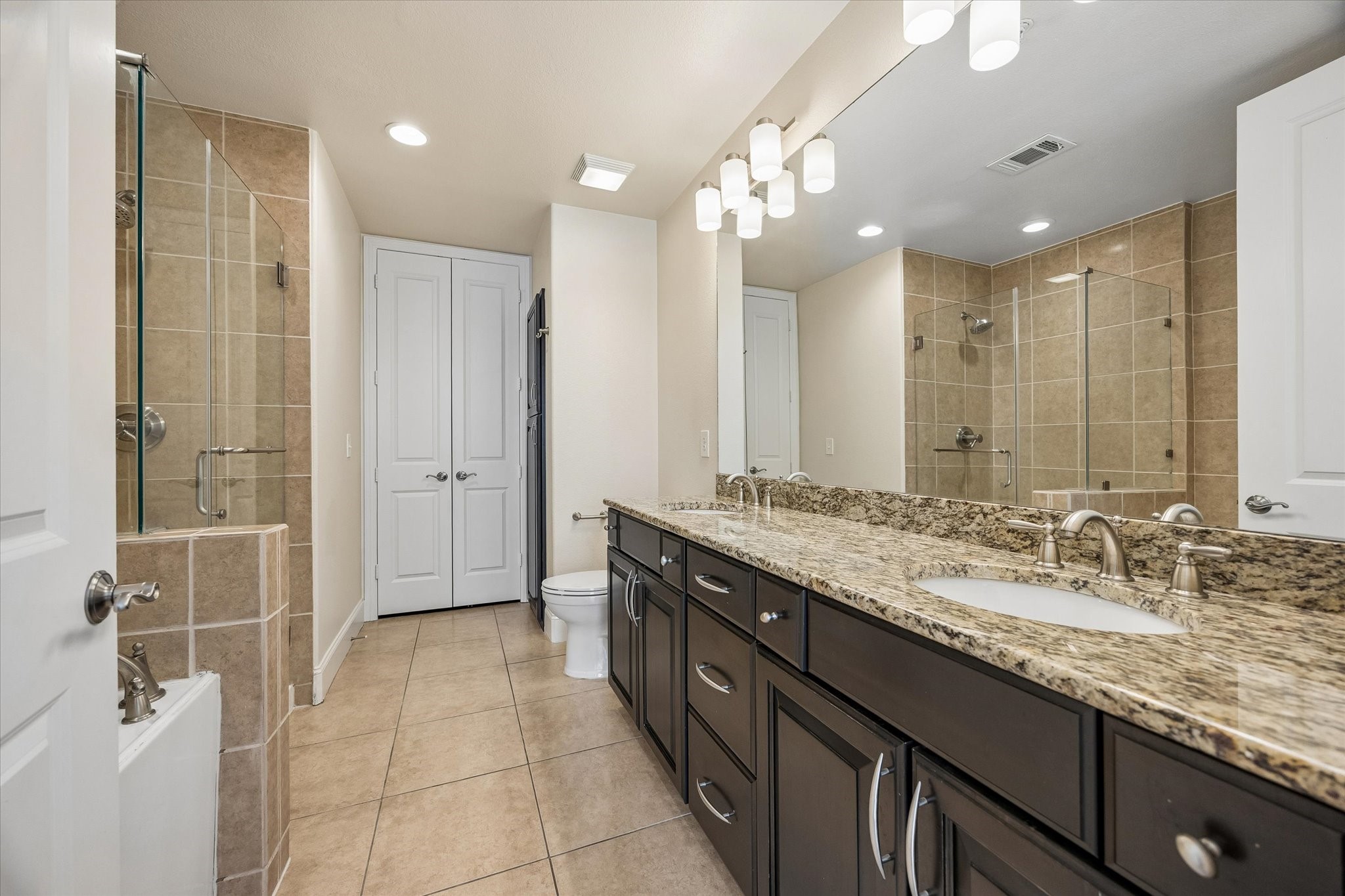 2120 Kipling Street, Unit 207 Houston, TX 77098 - Photo 18 of 35 Primary bedroom with double sinks and a massive closet