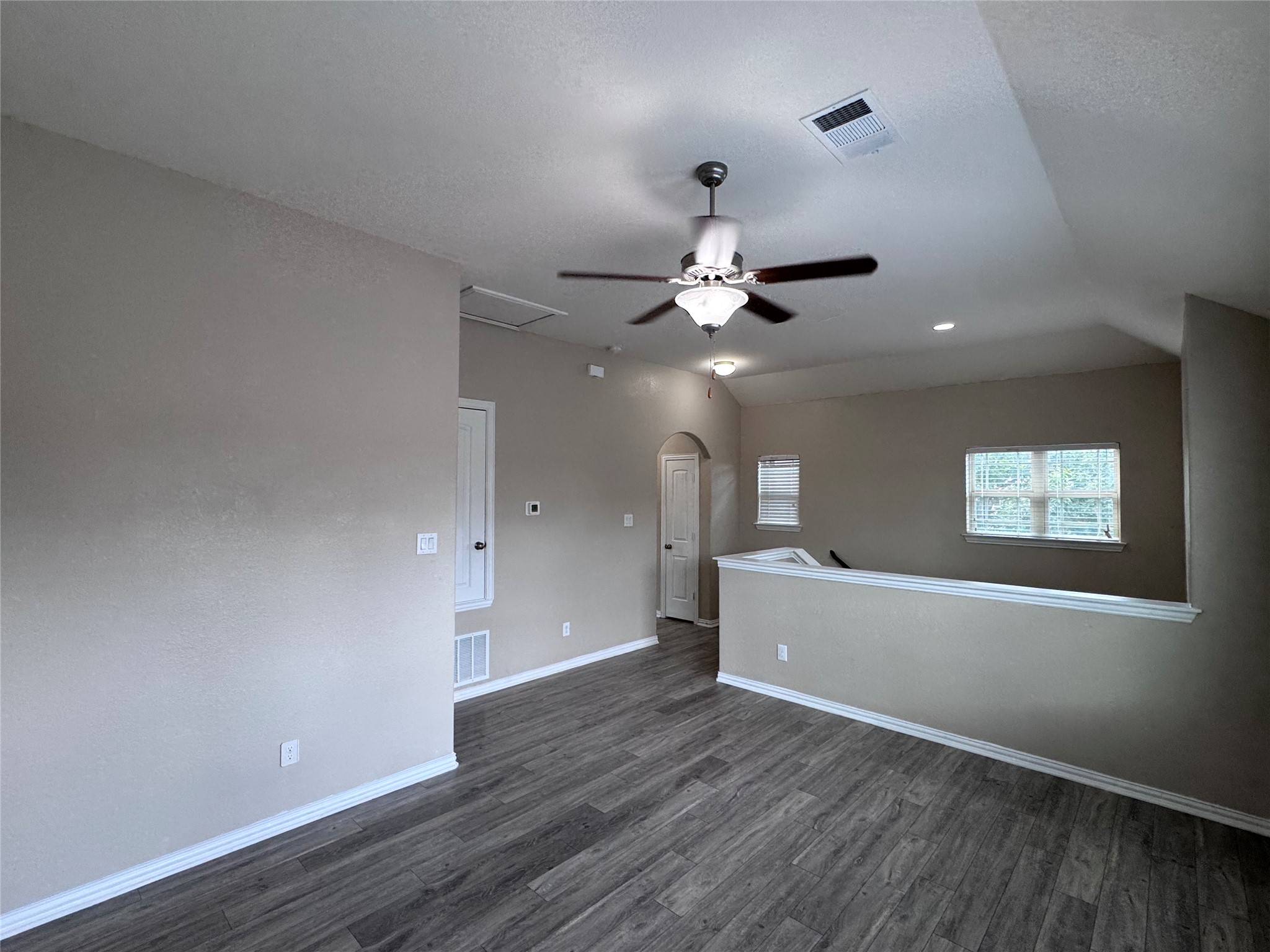 2605 Rough Berry Road Pflugerville, TX 78660 - Photo 20 of 40 A well-lit upper-level living space features rich wood-look flooring and a functional ceiling fan.