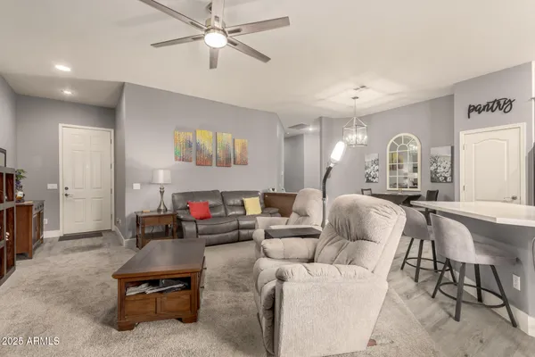 a living room with furniture and a chandelier
