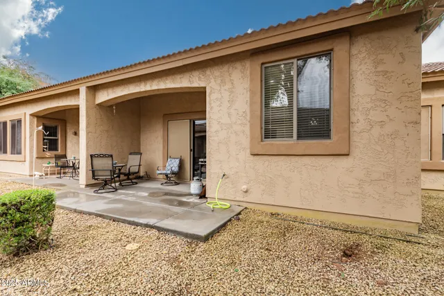 a front view of a house with sitting area
