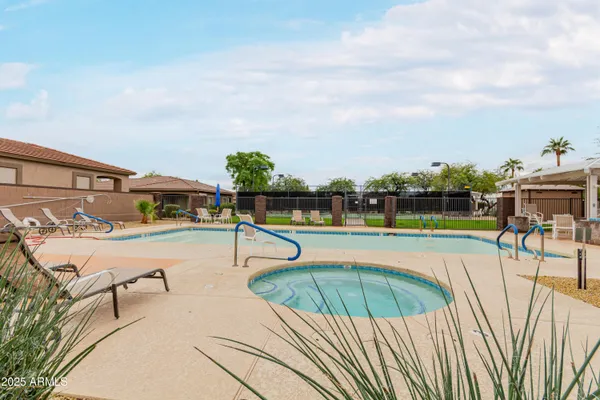 a view of a swimming pool with an outdoor seating and a yard
