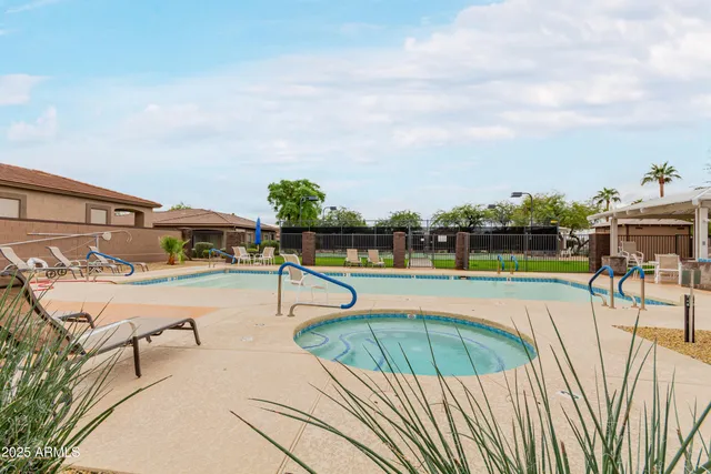 a view of a swimming pool with an outdoor seating and a yard