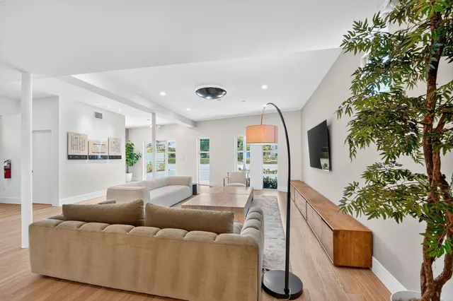 a living room with furniture and a potted plant