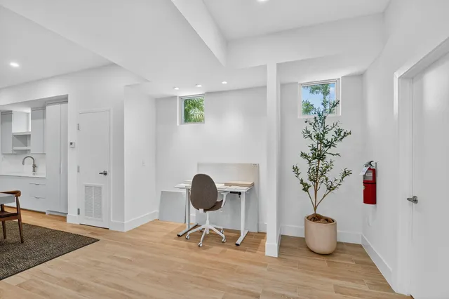 a view of a workspace room with wooden floor and chair