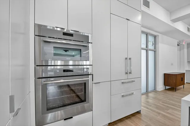 a kitchen with cabinets and stainless steel appliances