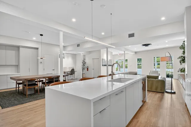 a large kitchen with kitchen island a sink a counter space and stainless steel appliances