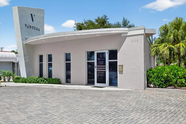 a view of a white house with a yard