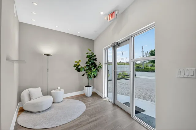 a living room with furniture and a potted plant