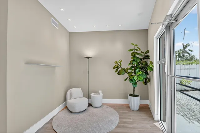 a living room with furniture and potted plant