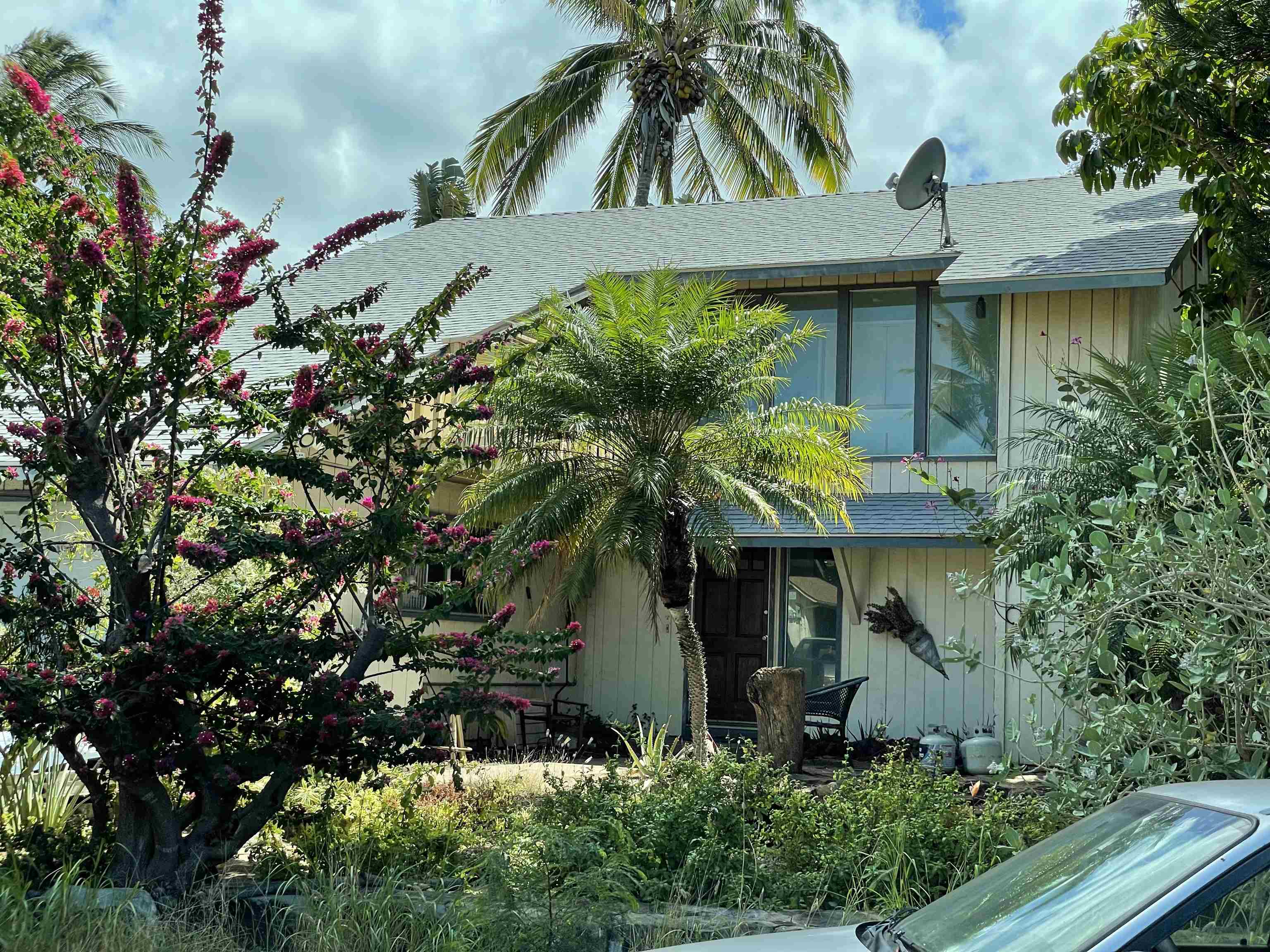 a front view of a house with a garden