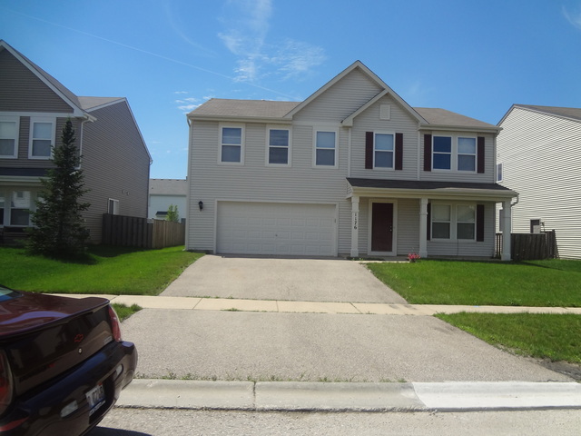 1176 Port Royal Road Pingree Grove, IL 60140 - Photo 1 of 1 a front view of a house with a yard and garage