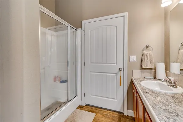 a bathroom with a granite countertop sink and a mirror