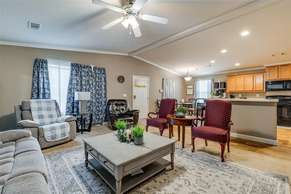 a living room with furniture and kitchen view