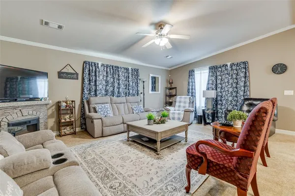 a living room with furniture and a fireplace