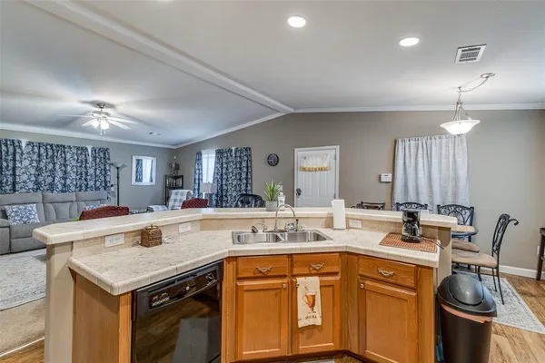 a kitchen with a stove sink and cabinets