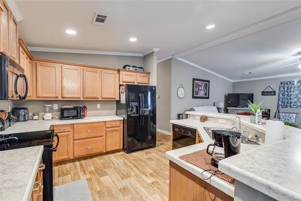 a kitchen with a refrigerator and cabinets