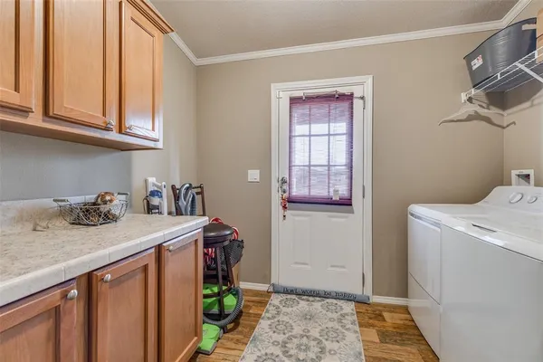 a utility room with sink dryer and washer