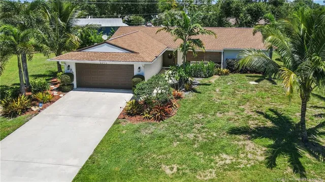 a aerial view of a house with yard and green space