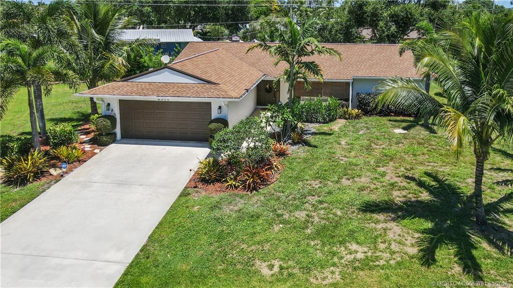 a aerial view of a house with yard and green space