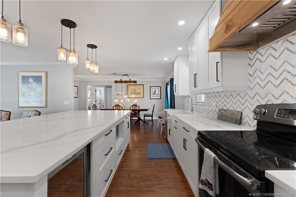 2916 Southeast Paramount Place Stuart, FL 34997 - Photo 12 of 38 a large kitchen with granite countertop lots of counter space and stainless steel appliances