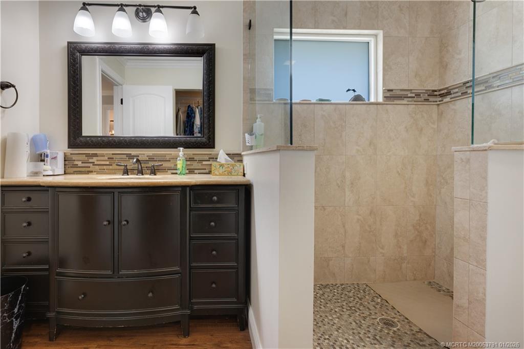 2916 Southeast Paramount Place Stuart, FL 34997 - Photo 19 of 38 a bathroom with a double vanity sink and a mirror