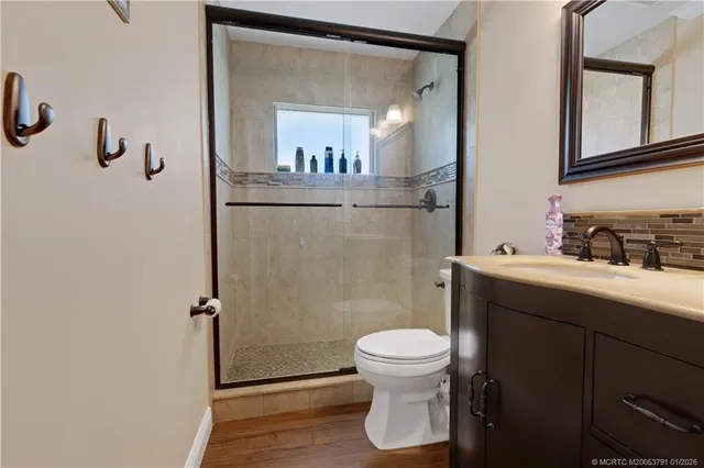 a bathroom with a sink a toilet and shower